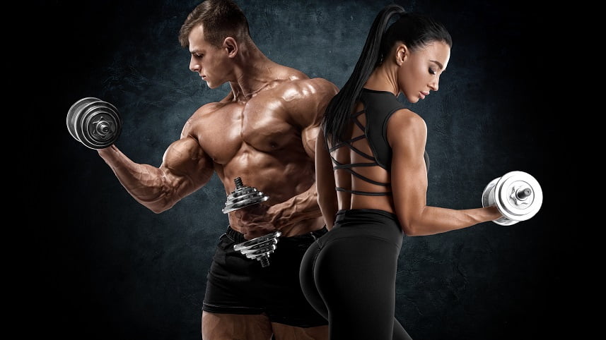 Sporty couple workout with dumbbells. Muscular man and woman showing muscles